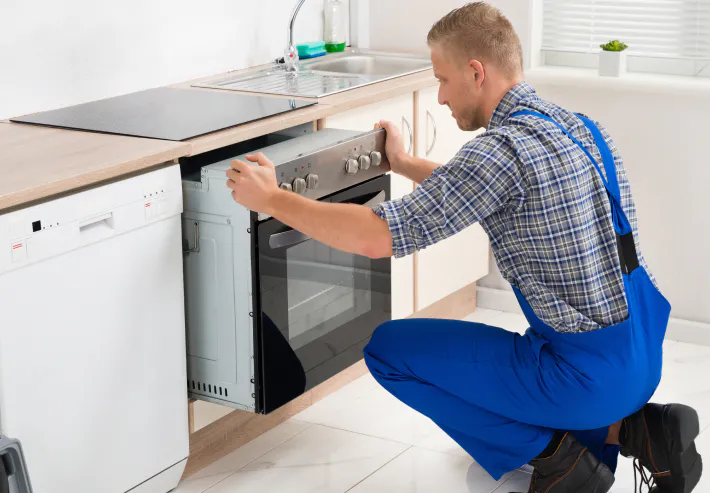 a man installing an oven newport de